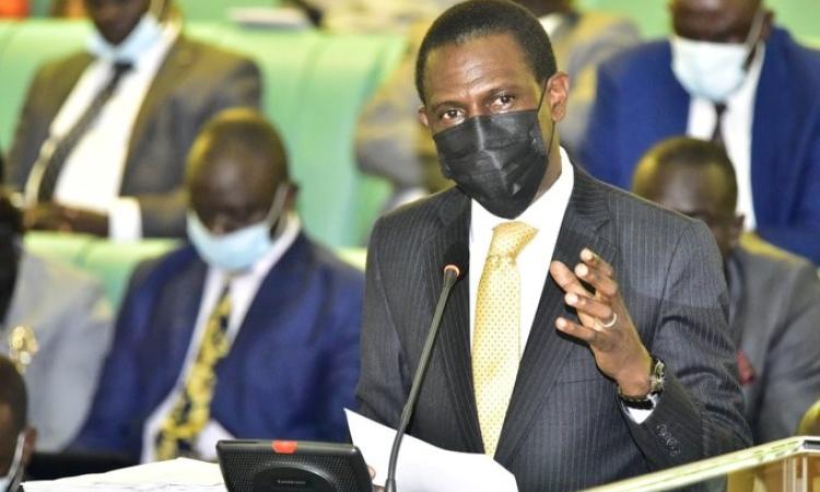 Attorney General of Uganda Mr. Kiryowa presenting the bills to Parliament